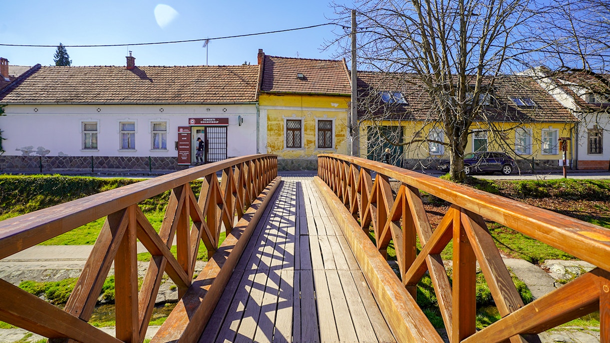 Wooden bridge leading to colorful houses in Szentendre village, Hungary.