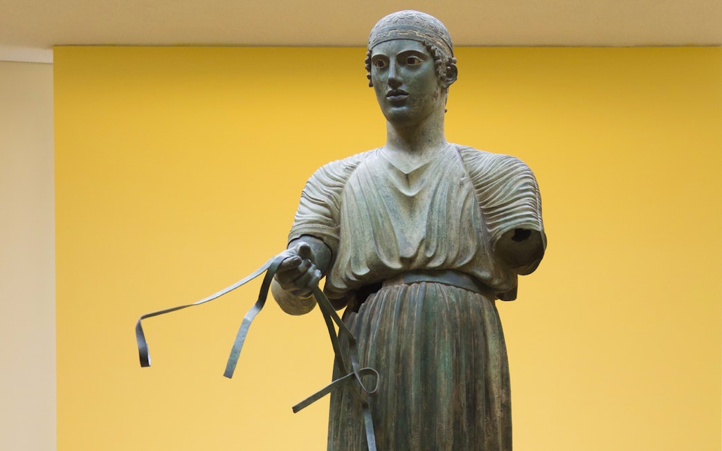 Ancient Greek bronze statue of a charioteer, Delphi Museum, Greece.