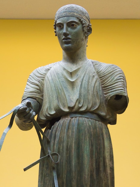 Ancient Greek bronze statue of a charioteer, Delphi Museum, Greece.