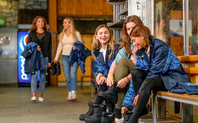 Guests preparing ski gear at Ski Dubai indoor resort.