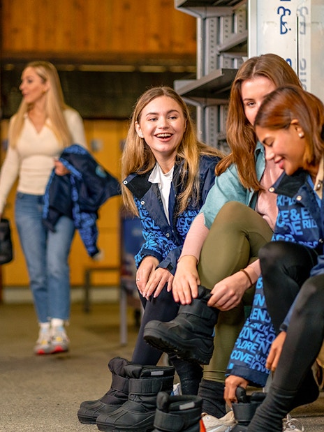 Guests preparing ski gear at Ski Dubai indoor resort.