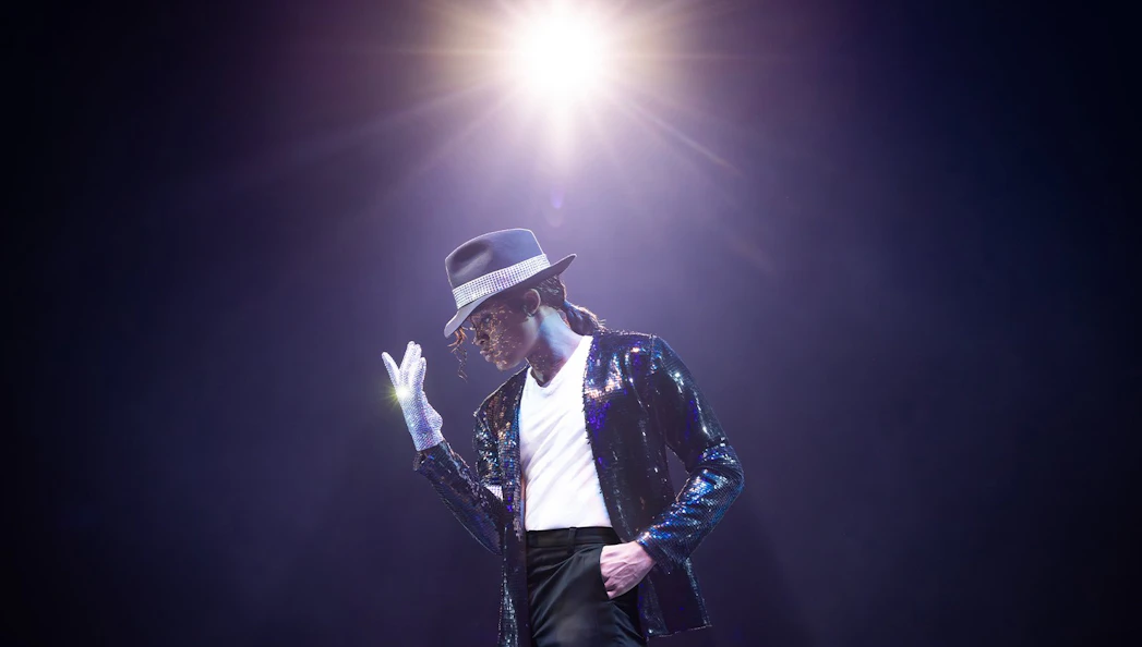 Performer in MJ the Musical on stage in Brisbane, wearing a sequined jacket and fedora.