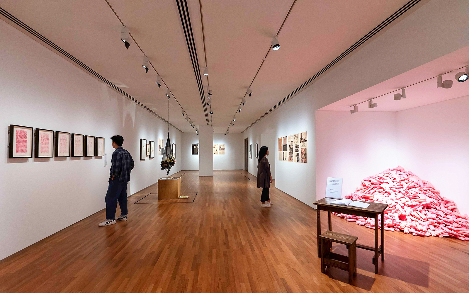 Visitors viewing art exhibits inside National Gallery Singapore.