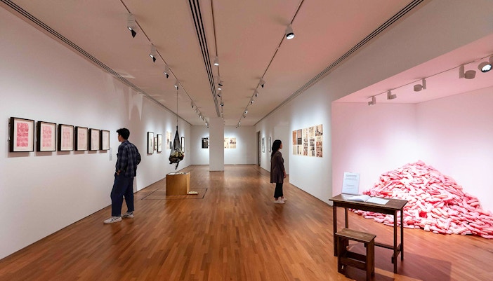 Visitors viewing art exhibits inside National Gallery Singapore.