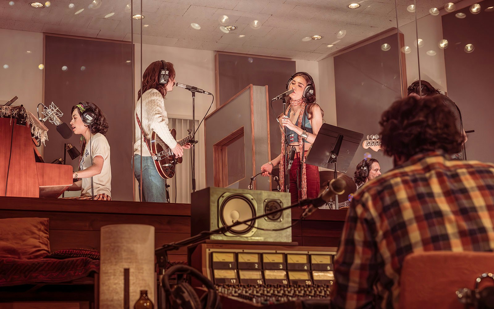 Recording session in a studio with musicians playing instruments and singing, related to Stereophonic.