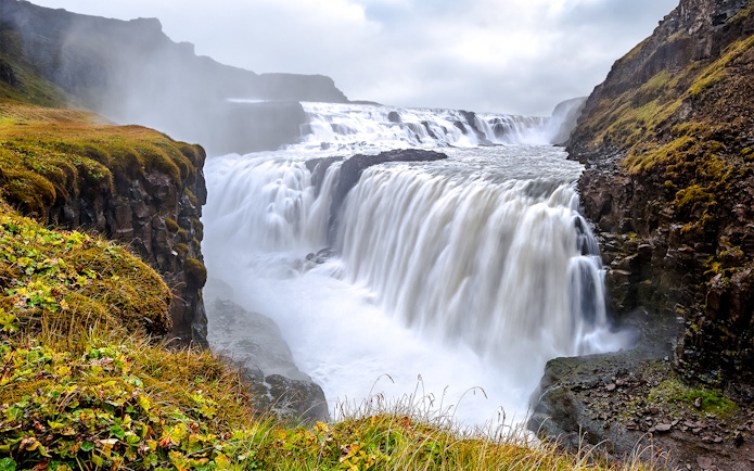 Gullfoss Waterfall cascading over rocky cliffs in Iceland.