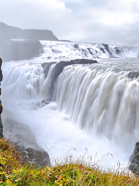 Gullfoss Waterfall cascading over rocky cliffs in Iceland.
