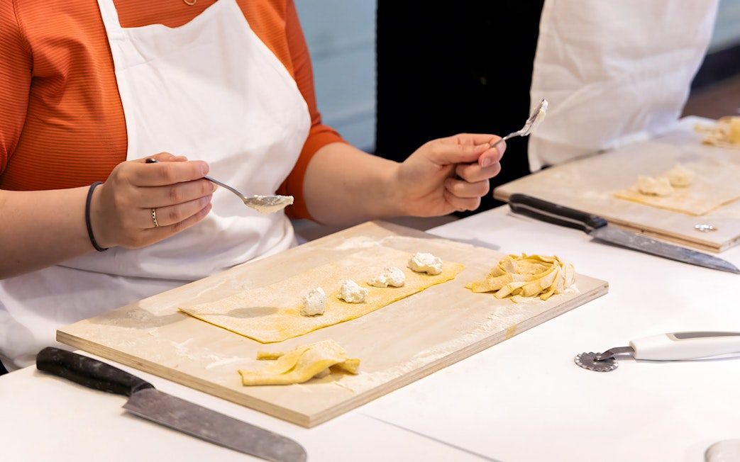 Person preparing ravioli during a cooking class in Rome near Piazza Navona.