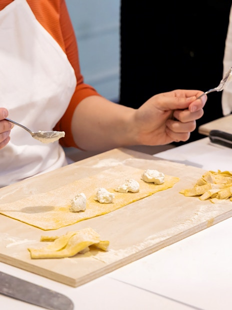 Person preparing ravioli during a cooking class in Rome near Piazza Navona.