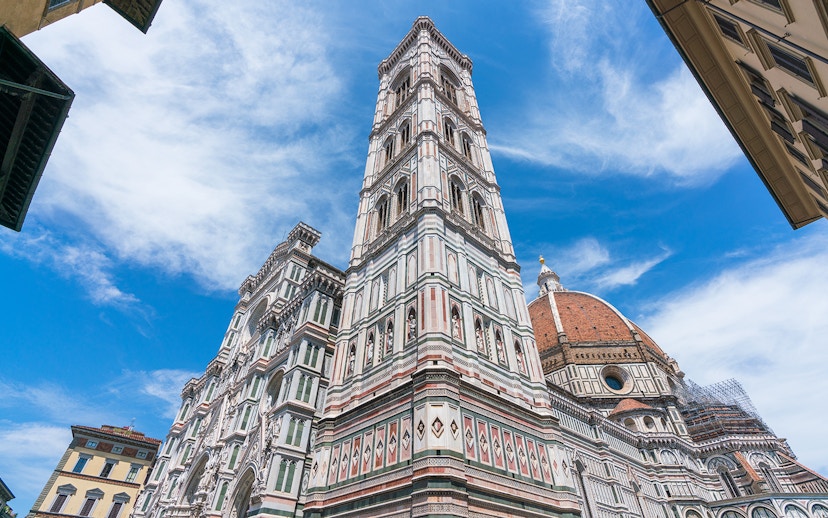 Giotto's Bell Tower beside Florence Cathedral under blue sky, part of Florence in a Day tour.