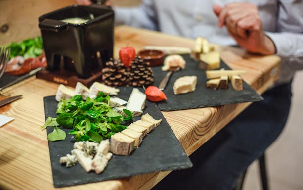 Cheese selection with greens at Paroles de Fromagers, Paris, France.