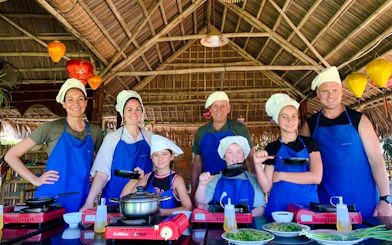 Group cooking class in Hoi An bamboo pavilion during 3 Heritage Craft Villages Bicycle Tour.
