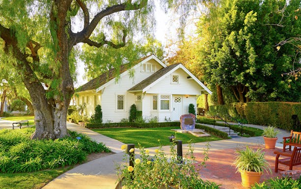 White house surrounded by trees and garden at Richard Nixon Presidential Library and Museum.