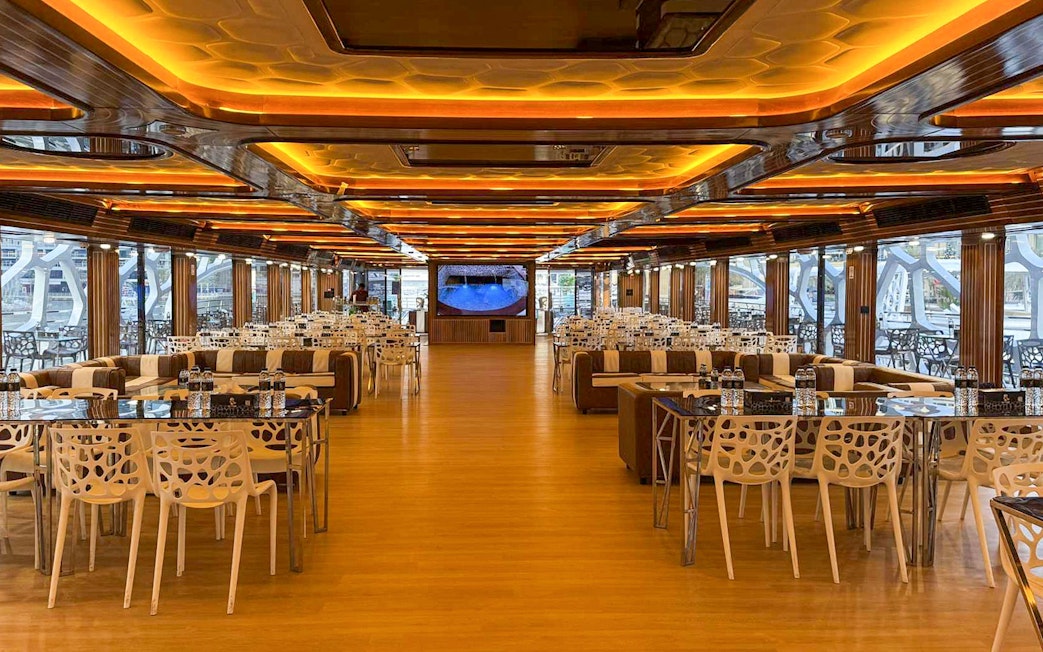Luxurious dining area on Lotus Mega Yacht in Dubai Marina with tables set for buffet dinner.