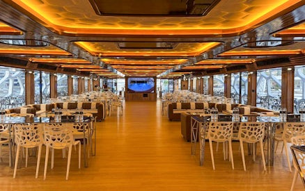 Luxurious dining area on Lotus Mega Yacht in Dubai Marina with tables set for buffet dinner.
