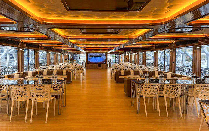 Luxurious dining area on Lotus Mega Yacht in Dubai Marina with tables set for buffet dinner.