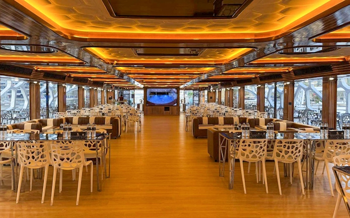 Luxurious dining area on Lotus Mega Yacht in Dubai Marina with tables set for buffet dinner.