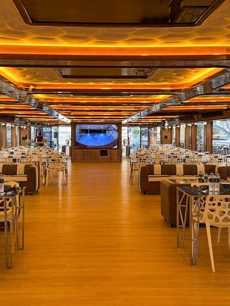 Luxurious dining area on Lotus Mega Yacht in Dubai Marina with tables set for buffet dinner.