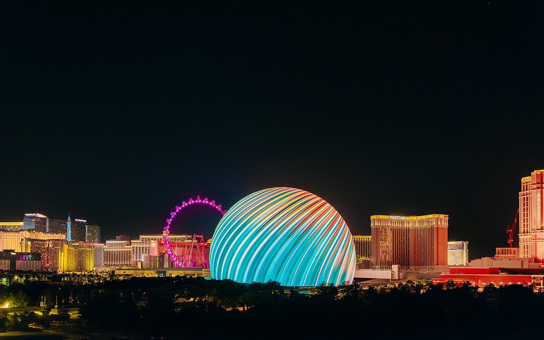 Exterior view of illuminated Sphere in Las Vegas skyline at night.