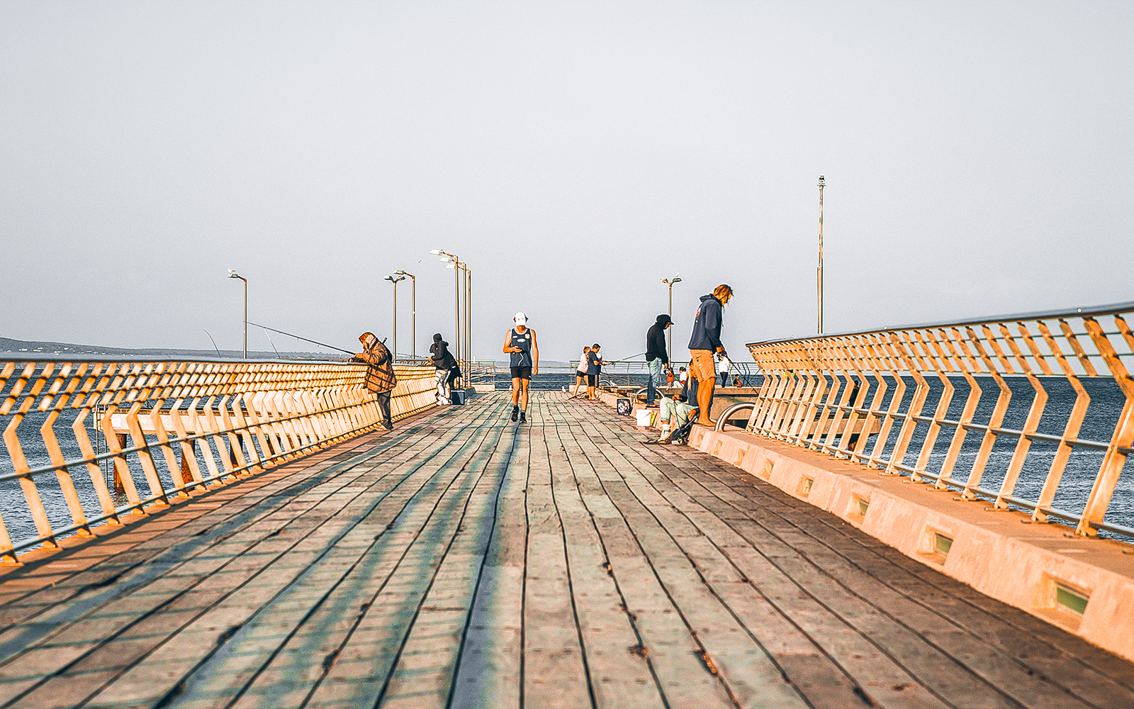 Fishing at Lorne Pier, Victoria with anglers casting lines into the ocean.