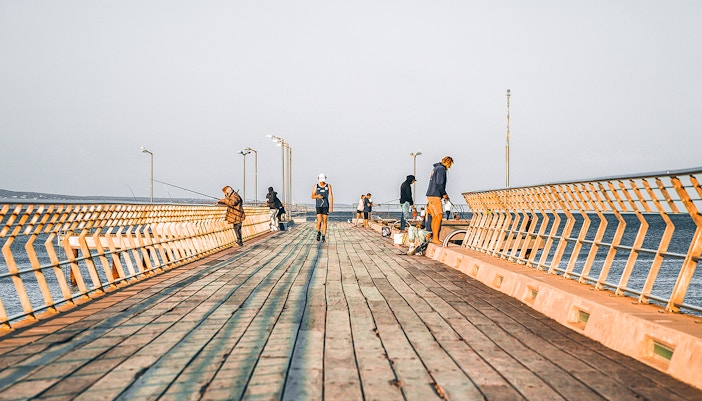 Fishing at Lorne Pier, Victoria with anglers casting lines into the ocean.