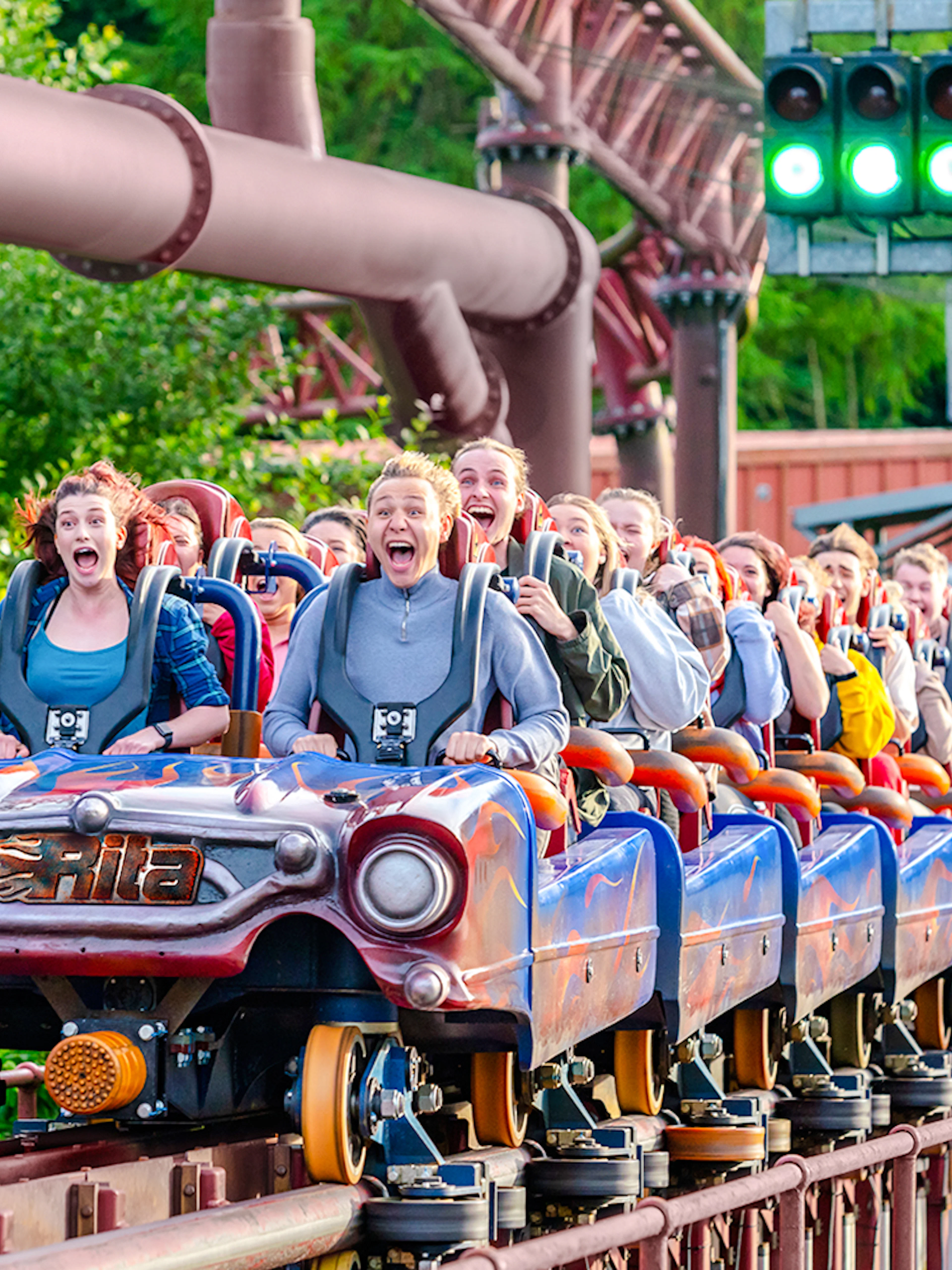 Riders on the Rita rollercoaster at Alton Towers, experiencing high-speed thrills.
