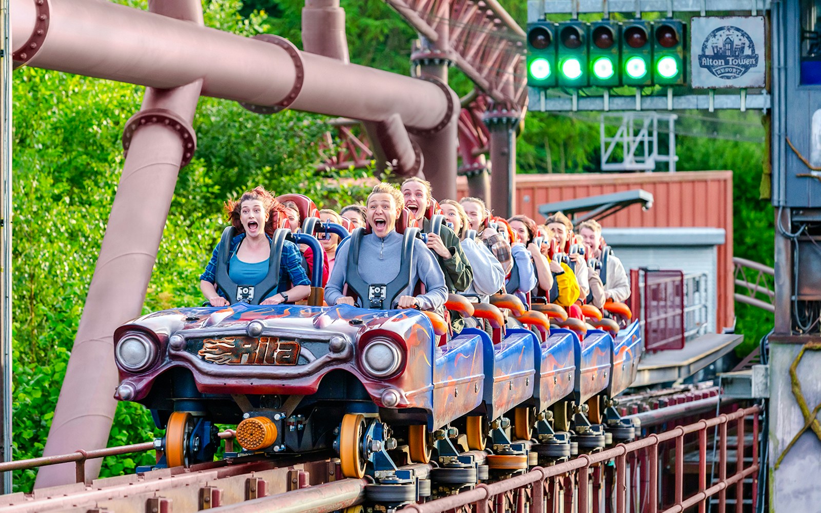 Riders on the Rita rollercoaster at Alton Towers, experiencing high-speed thrills.