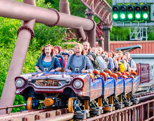 Riders on the Rita rollercoaster at Alton Towers, experiencing high-speed thrills.