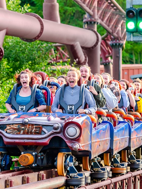 Riders on the Rita rollercoaster at Alton Towers, experiencing high-speed thrills.
