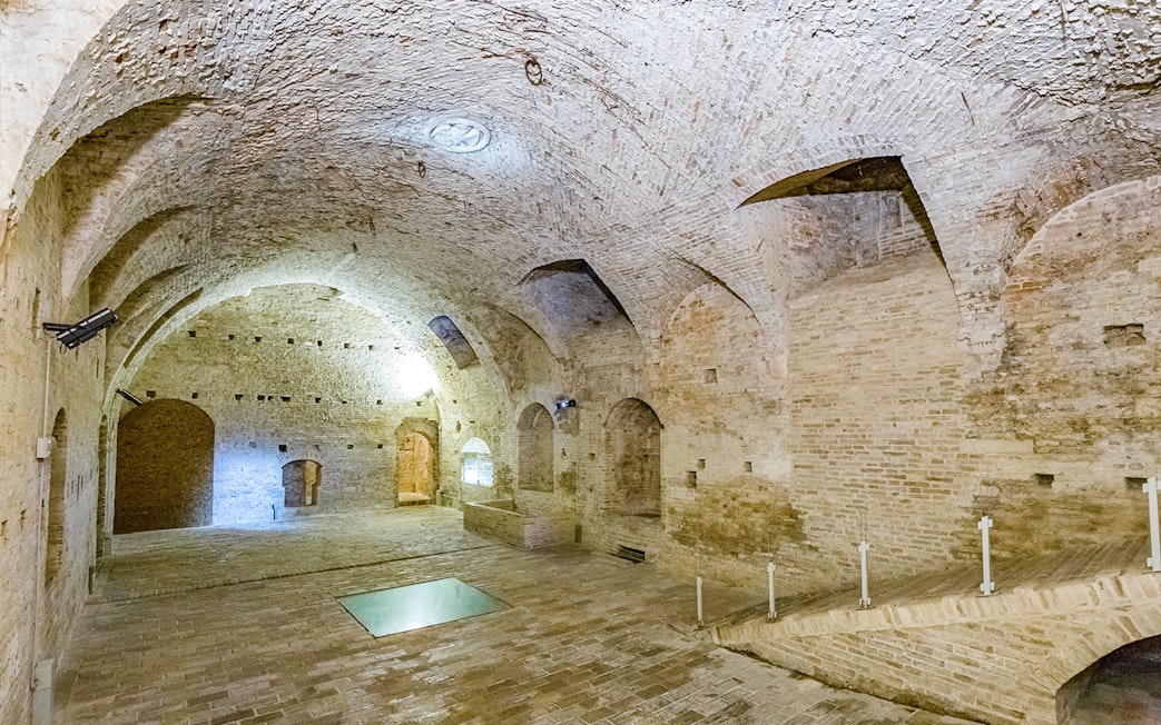 Ducal Palace interior with arched brick ceilings and stone floor.