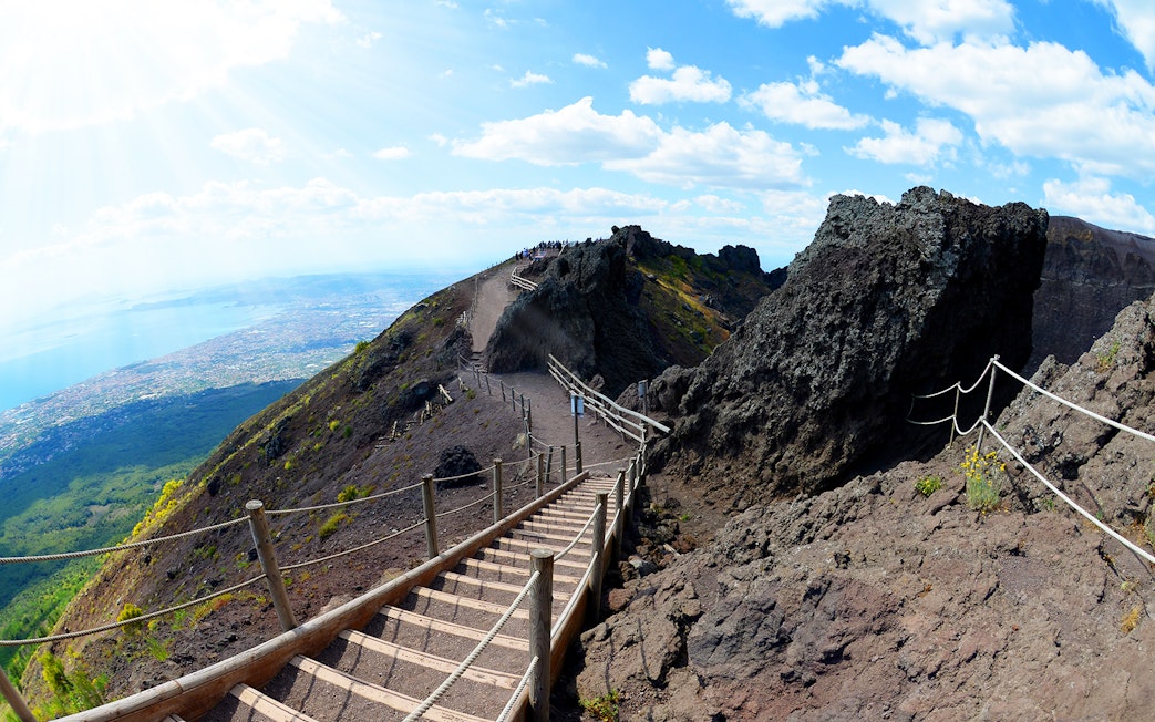 Pathway leading up Mt. Vesuvius with view of Naples coastline in the background.