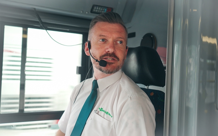 Live guide speaking on hop on hop off bus in Dublin.