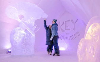 Guests admire ice sculptures inside Arctic SnowHotel.