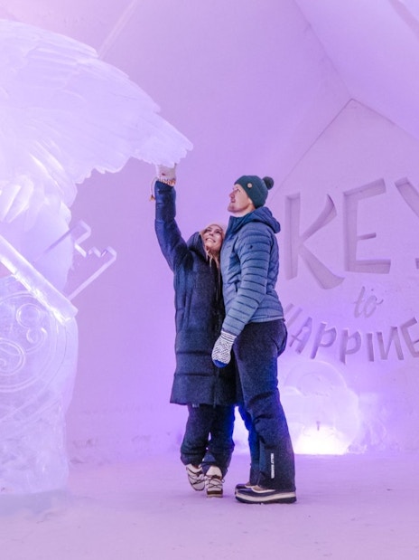 Guests admire ice sculptures inside Arctic SnowHotel.