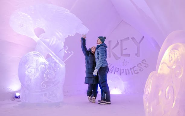 Guests admire ice sculptures inside Arctic SnowHotel.