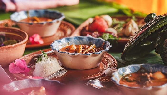 Oaxacan street vendor preparing traditional food in Oaxaca City, Mexico.