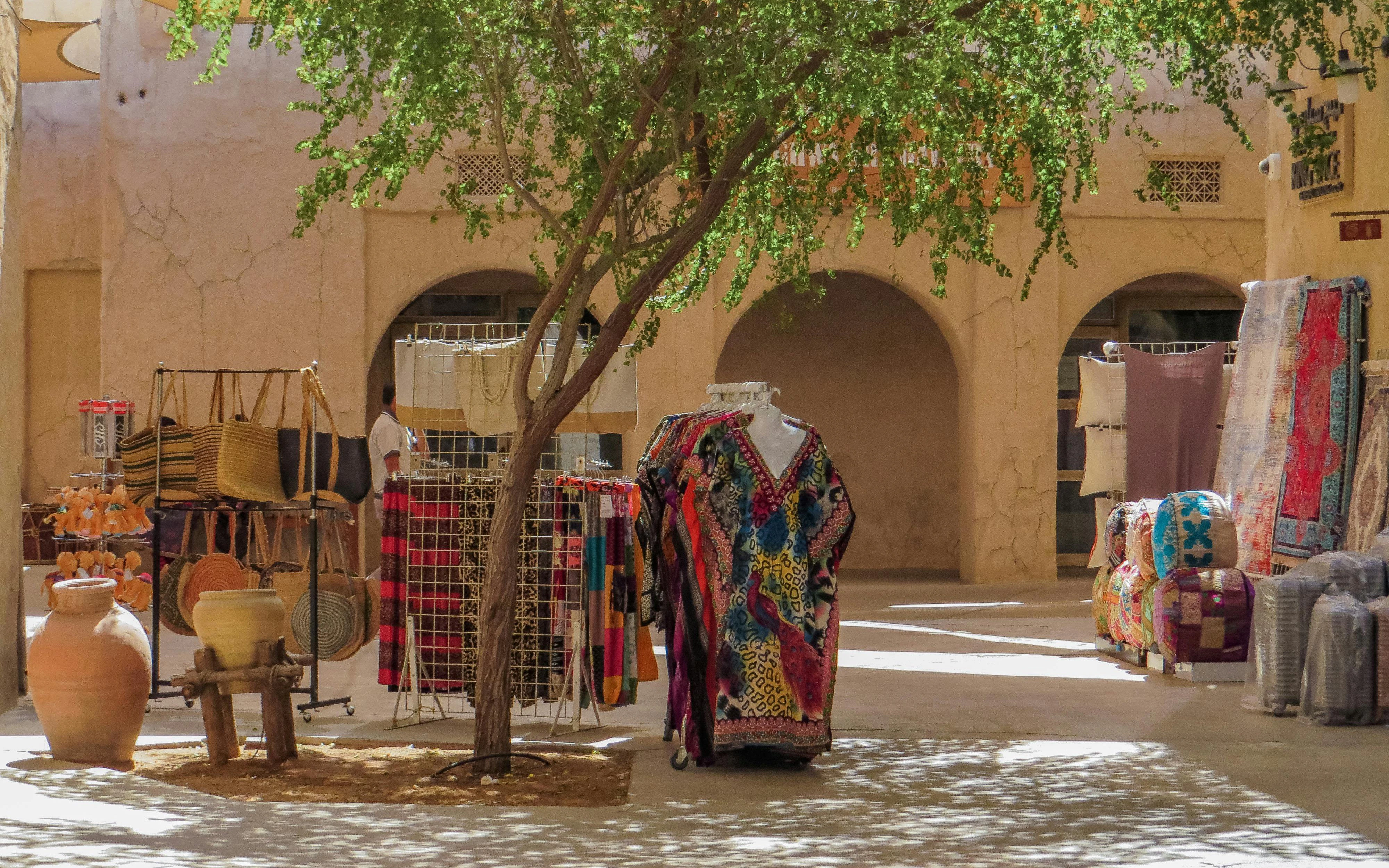 Shops and colorful textiles in the ancient covered souq, Dubai, United Arab Emirates.