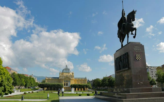 King Tomislav statue and Art Pavilion in Zagreb, Croatia, on a sunny day.