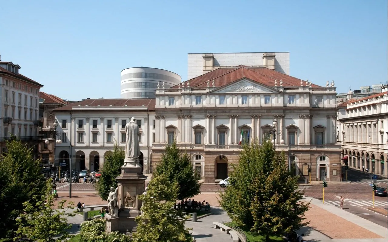La Scala opera house in Milan with surrounding plaza and statue.