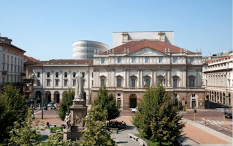 La Scala opera house in Milan with surrounding plaza and statue.