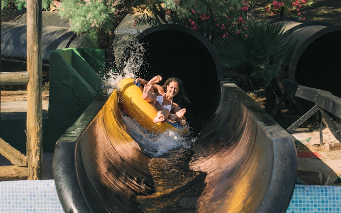 Person enjoying the Black Hole water slide at Aqualandia Benidorm, Spain.