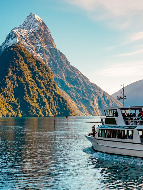 Cruise boat on Milford Sound with Mitre Peak in the background, Te Anau.