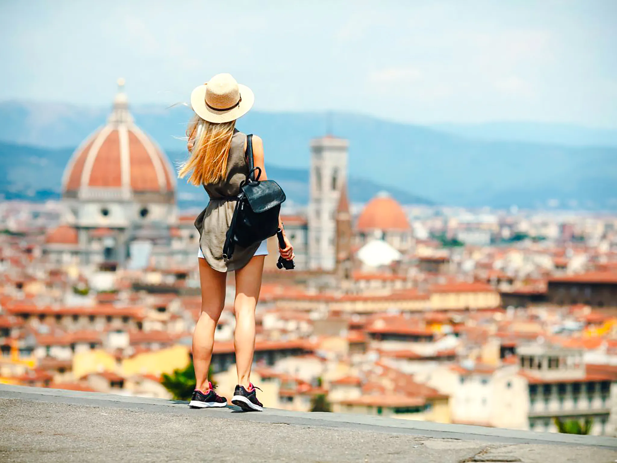 Woman overlooking Florence skyline with Florence Cathedral in view.