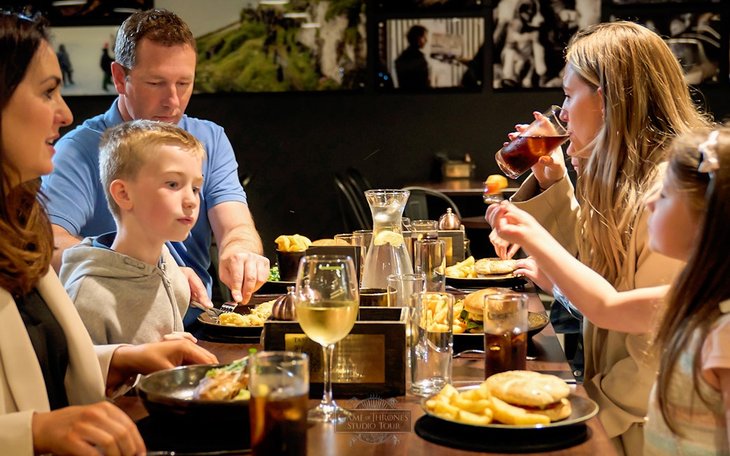 Family dining at a restaurant during Game of Thrones Studio Tour in Belfast.