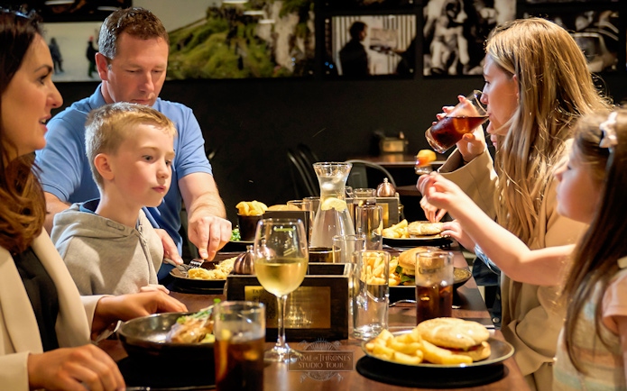 Family dining at a restaurant during Game of Thrones Studio Tour in Belfast.
