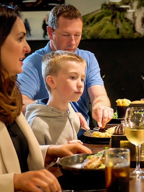 Family dining at a restaurant during Game of Thrones Studio Tour in Belfast.