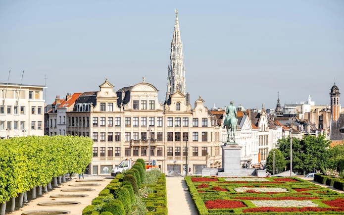 Mont des Arts garden with view of Brussels cityscape and equestrian statue.