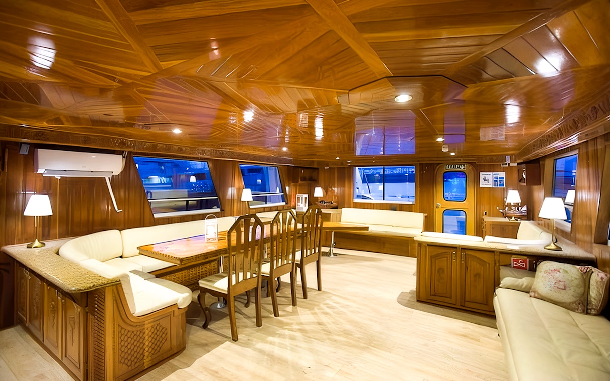 Interior of a yacht with wooden decor and seating, Northern Lights cruise.