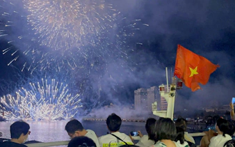 Fireworks over Han River with Vietnamese flag, viewed from a boat during Tau Rong Song Han tour, Dubai.