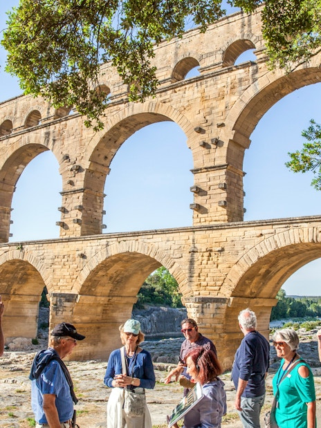 Visitors exploring Pont du Gard aqueduct in France with skip-the-line tickets.
